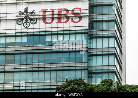 --FILE--A logo of Swiss bank UBS Group is pictured on an office building in Shanghai, China, 4 December 2017.   The Hong Kong authorities have decided Stock Photo