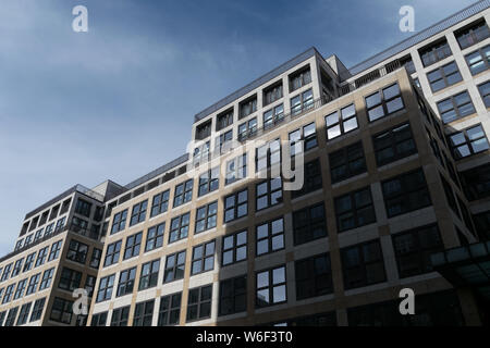 BERLIN, GERMANY - SEPTEMBER 26, 2018: Upwards perspective of the architecture of a wide business building, with square and reflective windows, at the Stock Photo