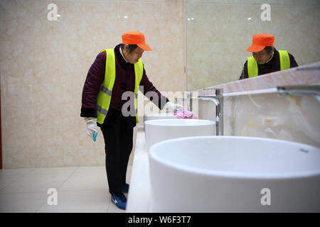 --FILE--A Chinese worker cleans a public toilet in Rugao city, east China's Jiangsu province, 30 November 2017.    A district urban management authori Stock Photo