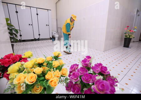 --FILE--A Chinese worker cleans a public toilet in Xi'an city, northwest China's Shaanxi province, 13 January 2017.   A district urban management auth Stock Photo