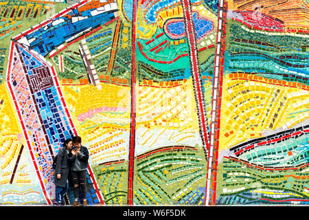 Visitors take photos in front of the colorful exterior facade of the Chongqing Luo Zhongli Art Museum on the Huxi Campus of Sichuan Fine Arts Institut Stock Photo