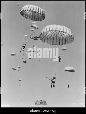 Paratroopers of the 187th Regimental Combat Team put on parachutes and ...