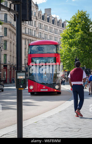 London, United Kingdom – August 13, 2017: Street life with a red bus driving in a street Stock Photo