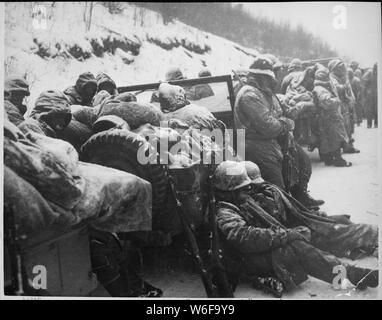 Astonished Marines of the 5th and 7th Regiments, who hurled back a surprise onslaught by three Chinese communist divisions, hear that they are to withdraw! Hagaru-ri, near Chosin Reservoir,; General notes:  Use War and Conflict Number 1392 when ordering a reproduction or requesting information about this image. Stock Photo