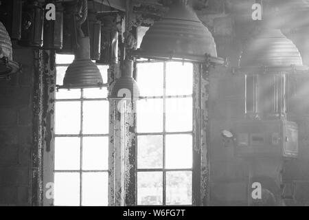 Old vintage Industrial interior with bright light coming through windows. Beautiful sunlight Stock Photo