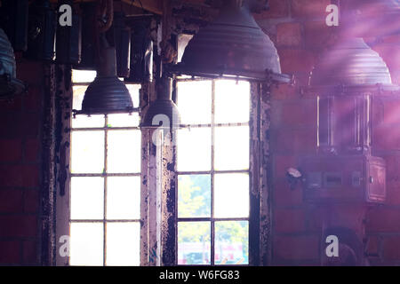 Old vintage Industrial interior with bright light coming through windows. Beautiful sunlight Stock Photo