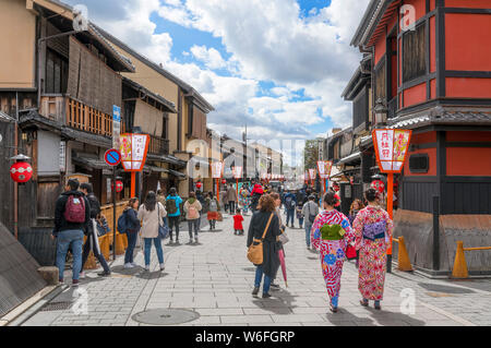 Young women wearing traditional kimonos on Hanamikoji-dori, a street in the historic Gion district of Kyoto, Japan