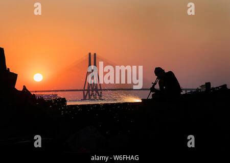 The image of Man working and Worli bandra sealink bridge, at Mumbai, India Stock Photo