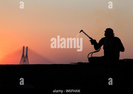 The image of Man working and Worli bandra sealink bridge, at Mumbai, India Stock Photo