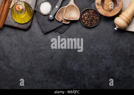 Cooking utensils and spices on stone kitchen table. Top view with copy space for your recipe Stock Photo