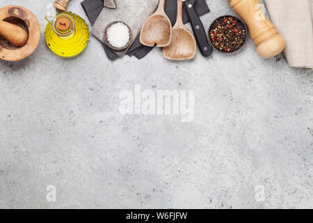 Cooking utensils and spices on stone kitchen table. Top view with copy space for your recipe Stock Photo