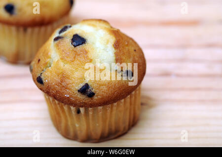 two small  muffins on table at market place Stock Photo