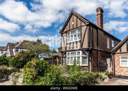 Neglected timber framed house with overgrown front garden, Green Lane, Edgware, London, HA8, England, UK. Stock Photo