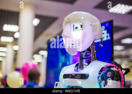 Portrait of white cute humanoid robot at robotic show Stock Photo