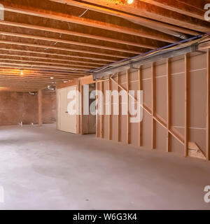 Square New home interior under construction with the wood framing visible Stock Photo