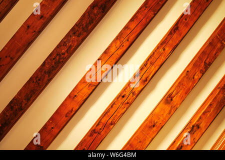 Diagonal timber pattern on beige background with gradient shadows. Wooden ceiling as abstract rustic grid background. Stock Photo