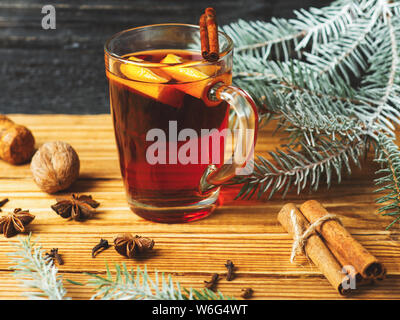 Autumn and winter seasonal mulled wine on a wooden table with spices Stock Photo