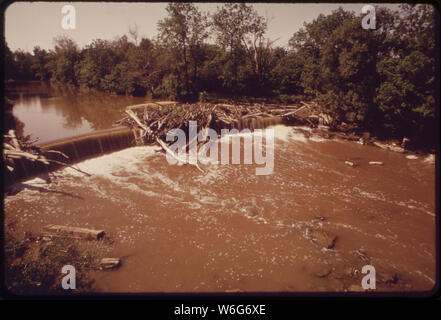 DEBRIS CHOKES THE POLLUTED ROCKY RIVER Stock Photo - Alamy