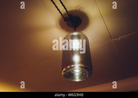 Standing brass chandelier with burning candles in shallow focus home setting. Stock Photo