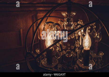 Standing brass chandelier with burning candles in shallow focus home setting. Stock Photo