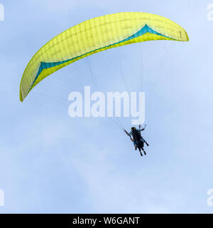 Flying High - A close-up view of a tandem paraglider flying high in the sky above Lookout Mountain near city of Golden, Colorado, USA. Stock Photo