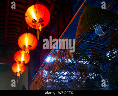 Lit red festive chinese lanterns hanging in the old chinese temple Stock Photo