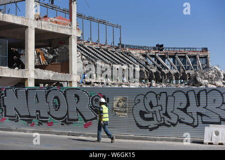 Madrid, Madrid, Spain. 1st Aug, 2019. A worker walks in front of Vicente Calderon as demolition works continue in Atletico de Madrid old stadium.Spanish football club Atletico Madrid makes 182 million euros from sale of three plots of land of the old stadium area. These have been purchased by Azora, CBRE, Vivenio, Renta CorporaciÃ³n and APG. They will be used for the construction of about 400 homes and common areas. Credit: John Milner/SOPA Images/ZUMA Wire/Alamy Live News Stock Photo