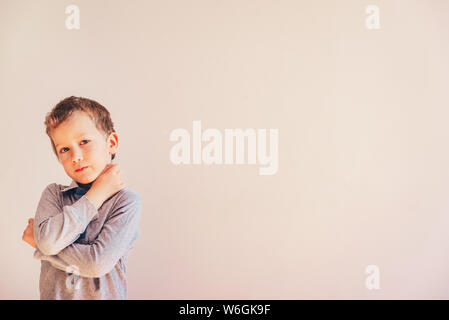 Thoughtful boy with doubts about his ideas, on white background with area copy space. Stock Photo