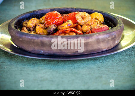 Tasty fried prawns with tomatoes and peppers. Shrimp and vegetables fried in a sauce with vegetable oil and soy sauce Stock Photo