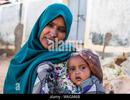 Ethiopian woman holding a boy in Harar Jugol, the Fortified Historic Town; Harar, Harari Region, Ethiopia Stock Photo