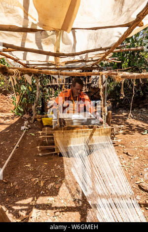 Konso man weaving cloth on his loom; Karat-Konso, Southern Nations Nationalities and Peoples' Region, Ethiopia Stock Photo