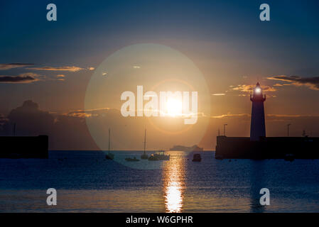 Midsummer sunrise over Donaghadee harbour and lighthouse, County Down, Northern Ireland Stock Photo