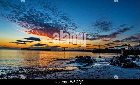 Midsummer sunrise over Donaghadee harbour and lighthouse, County Down, Northern Ireland Stock Photo