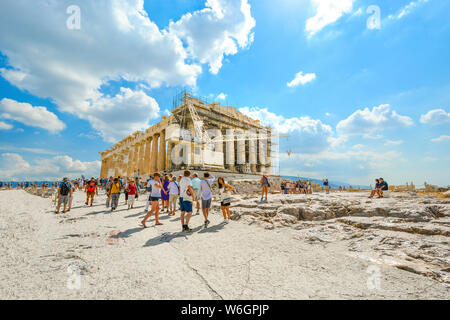 The ancient Parthenon on Acropolis Hill above Athens Greece on a hot summer day with crowds of tourists Stock Photo