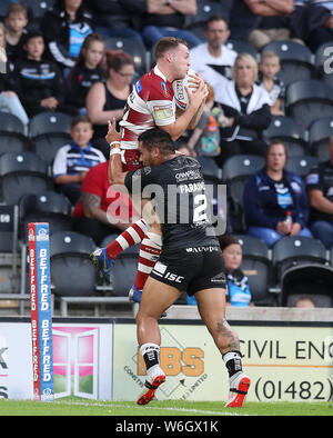 Wigan Warriors Liam Marshall catches the ball above Hull FC's Bureta Faraimo then goes over the line to score a try, during the Betfred Super League match at the KCOM Stadium, Hull. Stock Photo