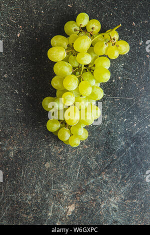 Tasty green grapes. White grape on old kitchen table. Stock Photo