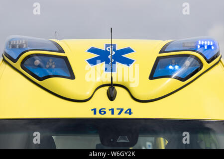 Dutch ambulance Mercedes-Benz Sprinter with active blue emergency lighting Stock Photo