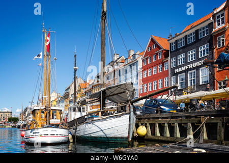 Pair of masted wooden sailing boat in the canal in the Nyhavn district of Copenhagen, Denmark on 18 July 2019 Stock Photo