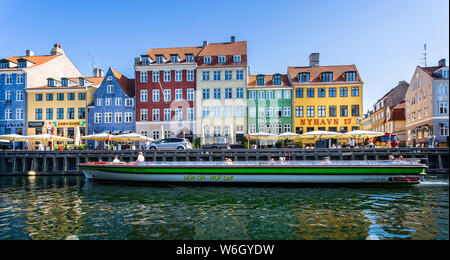 Tourist canal boat in the Canal at historic Nyhavn district in Copenhagen, Denmark on 18 July 2019 Stock Photo