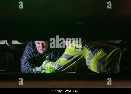 Parliament Square, London, UK. 2nd December, 2015.  A female protester locks herself underneath a lorry outside the Houses of Parliament in demonstrat Stock Photo