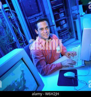 Working in a computer server mroom Stock Photo