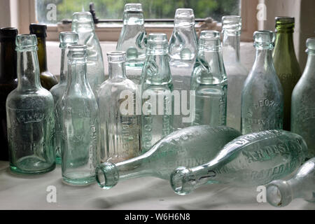 A collection of old glass bottles at Magdalen College Museum in Wainfleet, Lincolnshire, UK Stock Photo