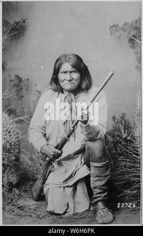 Geronimo (Goyathlay), a Chiricahua Apache; full-length, kneeling with ...