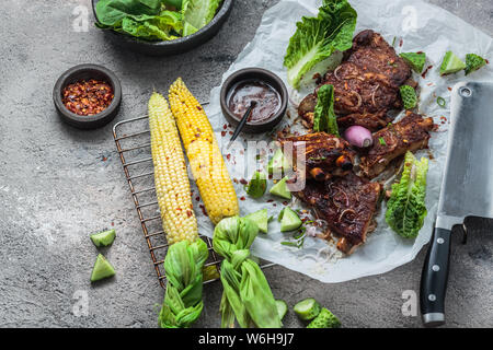 Pork ribs and corn on concrete background, copy space Stock Photo