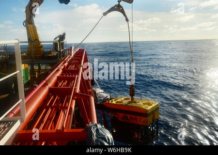 ROV crew team launching ROV to ocean for under water inspection Stock Photo