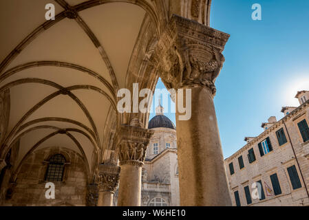 Detail of columns in the Rector's Palace facade and the Cathedral in the background; Dubrovnik, Dubrovnik-Neretva County, Croatia Stock Photo