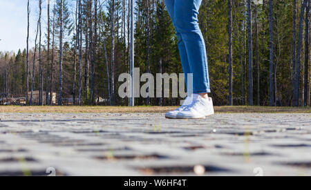 Girl stands on modern urban paving stones Stock Photo