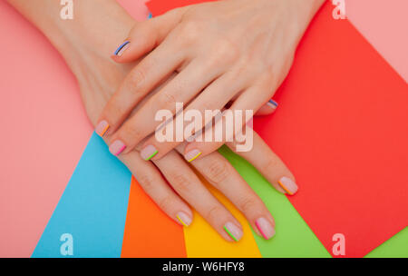 Modern stylish manicure rainbow or summer mood, on a pink table with color envelopes Stock Photo