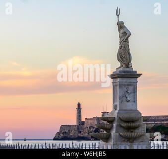 Morro Castle at sunset, with a statue of Poseidon with trident in the foreground; Havana, Cuba Stock Photo