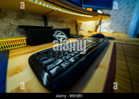 Stylish black keyboard on wooden table. Desktop table Stock Photo
